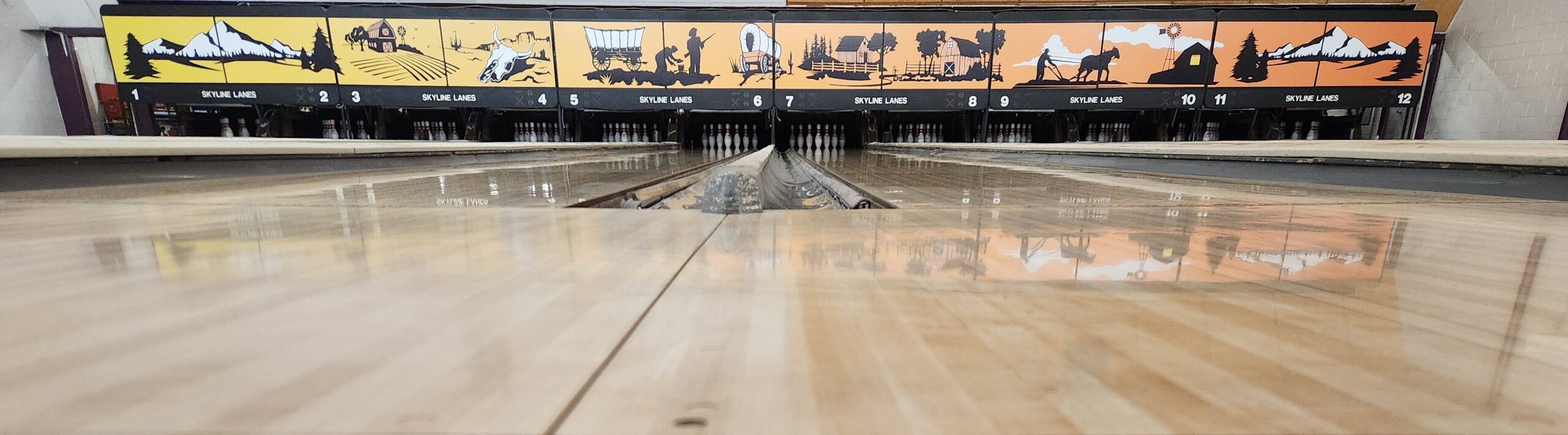 12 lane bowling alley with polished floors.